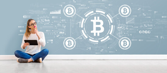 Bitcoin theme with young woman holding a tablet computer