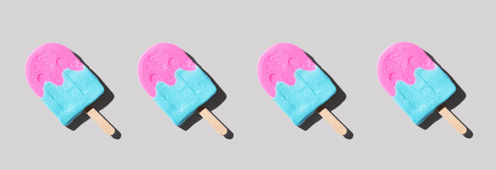 Pink and blue popsicles with shadow - flat lay