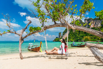 Traveler woman relaxing on swing joy nature view scenic landscape Phakbia beach Krabi, Attraction famous place tourist travel Phuket Thailand summer holiday vacation trip, Beautiful destination Asia - obrazy, fototapety, plakaty