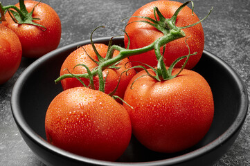tomatoes on a black bowl Closeup