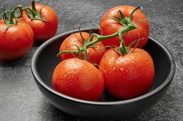 tomatoes on a black bowl 