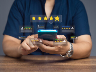 Satisfaction and feedback surveys. Customer using a smartphone gives the five-star icon a rating of...