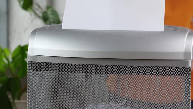 Shredding Confidential Documents. Paper Shredding Services and Document Destruction. Paper shredder to cut sheets of paper into fine particles