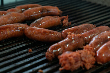 Grilled juicy chorizo sausages on a grill