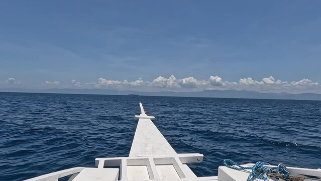 Riding a Bangka Boat with Pescador Island and Negros at the Horizon during an Island Hopping Tour in Moalboal, Cebu, Philippines