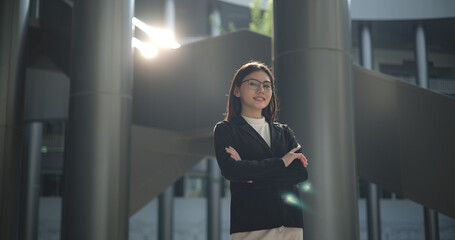 Portrait of Young woman dressed in formal business standing in workplace.