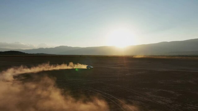 Four-by-Four Vehicle Driving In The Dusty Dry Lagoon Of Sayula At Dusk In Jalisco, Mexico. - aerial