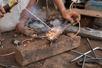 Welders work on welding metal. Men working in welding workshop
