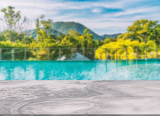 Fototapeta na wymiar Beautiful marble table or desk floor, little shiny surface, perspective view, the background of rooftop swimming pool and mountain scape and sky, Empty space for products to put on the table.