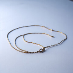 silver necklace on blue