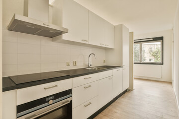 a kitchen with white cupboards and black counter tops on the counters in this is an example of modern design