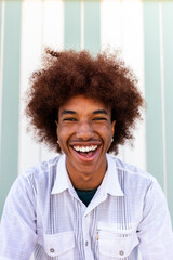 Headshot of happy African American Black young man smiling looking at camera. Summertime.