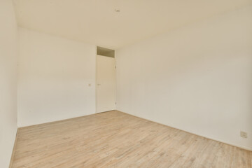 an empty room with white walls and wood flooring the room is clean and ready to be used for storage