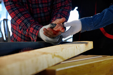 Accident of carpenter mistake or remiss while attempt to grab wood in work, sharp saw blade is...