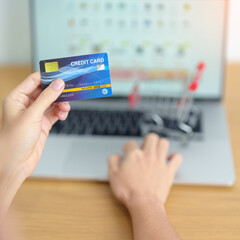 woman hand holding credit card and using laptop with mobile phone for online shopping while making order. Marketplace platform website, technology, ecommerce, shipping delivery and online payment