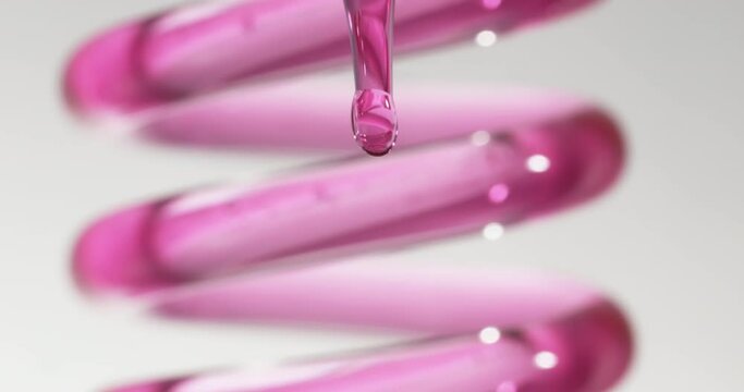 Slow Motion A drop of pink chemicals from a glass dropper tube and the movement of pink chemicals in a spiral glass tube