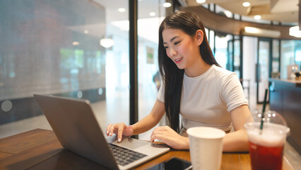 Business freelance asian woman using laptop computer at cafe urban lifestyle