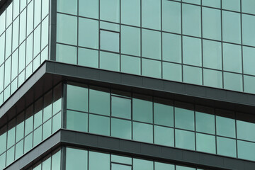 Fototapeta na wymiar Abstract urban background. Mirror windows of a multi-storey business center or office building.