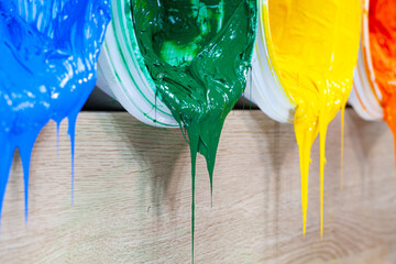 green yellow and orange paints are dripping from white barrel..high quality 4k video.colorful of paint background..plastisol ink is specially for print on tee shirts and any fabric.