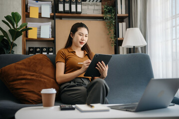 Asian business woman using laptop computer at modern home office