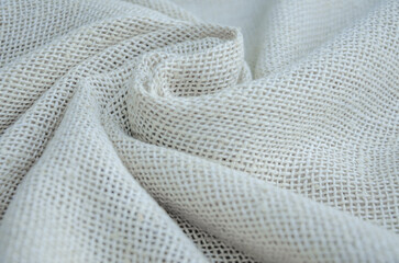 Textured background made of light-colored fabric