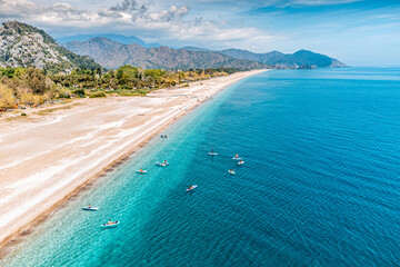 Aerial view of a Cirali beach in Turkey with group of sup boarders swimming in the sea. Paradise...