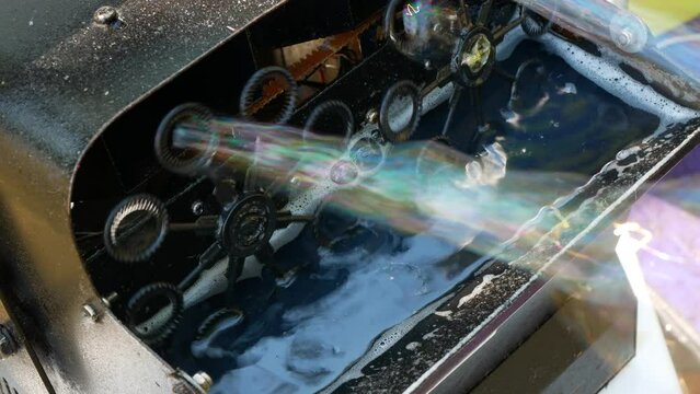 Bubble maker at work, selective focus. Bubble machine blowing non-stop soap bubbles for kids and adults entertainment