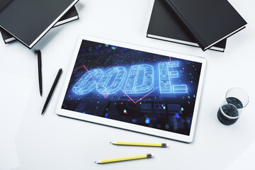 Creative Code word sign on modern digital tablet display, international software development concept. Top view. 3D Rendering