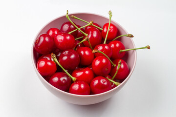 Obraz na płótnie Canvas Bowl of cherries on a gray background. Fresh natural organic cherries.