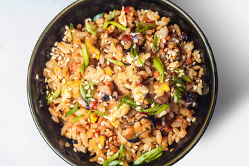 A sizzling wok filled with a delicious mix of vegetables, lentils, rice and meat creating an aromatic and healthy vegetarian dish for dinner.
