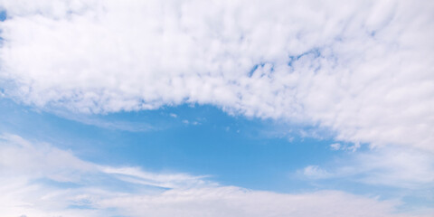 Blue sky with white altocumulus clouds on a daytime. Panorama