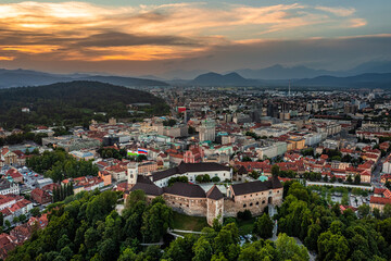Fototapeta na wymiar Ljubljana, Slovenia - Aerial panoramic view of Ljubljana Castle (Ljubljanski grad) on a summer afternoon with skyline of the capital of Slovenia and colorful sunset sky
