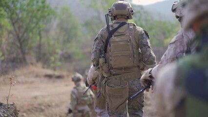 Team of U.S. Army marine corps soldier military war with gun weapon participating and preparing to attack the enemy in Thailand during exercise Cobra Gold training in battle. Combat force.