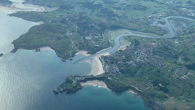 Aerial view of Suances bay, near Torrelavega, in Santander, Spain. Shot from an airplane cabin during a left turn at 5000m high. A pilot&rsquo;s perspective.