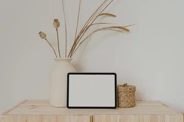 Foto op Canvas Tablet pad screen with empty free copy space for mock up, clay flowerpot with dried grass, rattan casket. Bright aesthetic social media branding, online shopping template © Floral Deco