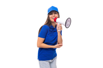 adorable european young brunette woman promoter in blue t-shirt and cap with loudspeaker