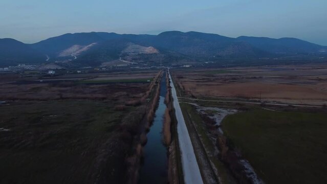 Aerial Over Fields And Canal, Approaching Marble Mining Site. Environment.