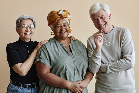 Diverse group of senior people posing together and smiling at camera