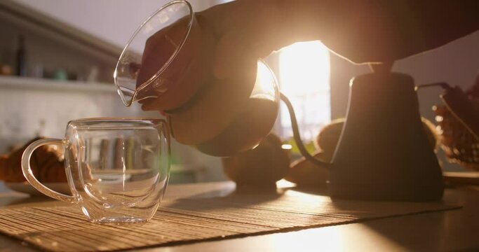 Slow motion of barista pour fresh chemex alternative way brew coffee in glass