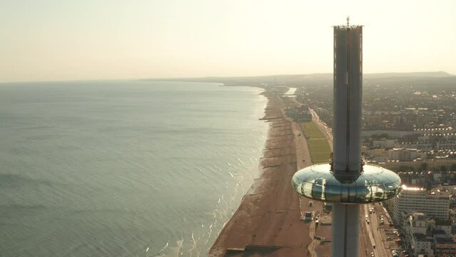 Tight circling aerial shot of i360 viewing platform Brighton with Hove in the background