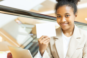 Happy smiling African woman showing blank paper card, concept education, tutoring, language learning