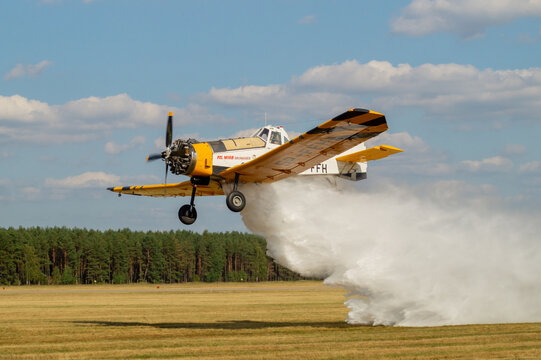 PZL M18 Dromader firefighting aircraft during discharge of extinguishing agent
