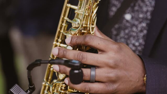 Close-up of a black man playing jazz on saxophone