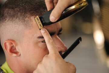 Close-up of barber use trimer for making modern hair cut. Barber shop