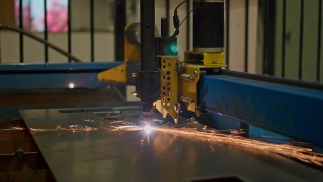 A laser machine cutting through metal to create a logo with sparks coming out.