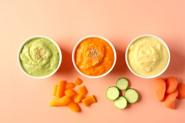 Bowls with healthy baby food on a colored background. Carrot, cucumber. Generative AI