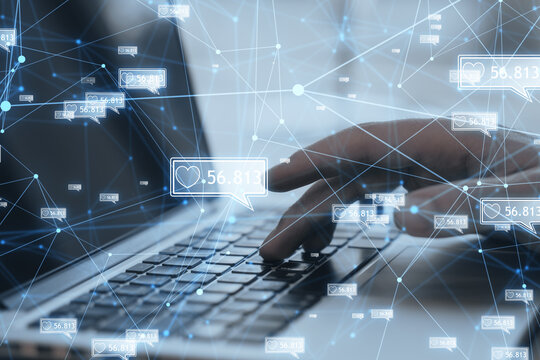 Concept of network and internet communication. Close up of male hands using laptop keyboard with creative polygonal likes network on blurry background. Double exposure.
