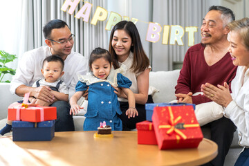Portrait of happy love asian big family father and mother with asian baby and little girl happy birthday, party, celebration, cake, surprise, grandfather with grandmother smiling together.Family party