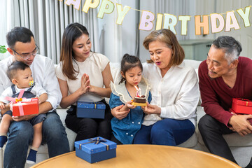 Portrait of happy love asian big family father and mother with asian baby and little girl happy birthday, party, celebration, cake, surprise, grandfather with grandmother smiling together.Family party
