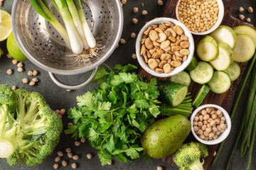 Clean eating background, fresh green vegetables with beans top view, balanced vegetarian food